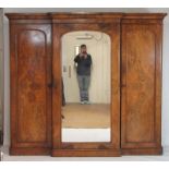 A Victorian walnut wardrobe, the cornice over a central mirrored door enclosing slides and drawers,