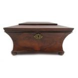 A 19th century rosewood tea caddy of sarcophagus form with wasted sides,