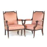 A pair of 19th century mahogany open arm chairs upholstered in a floral pink fabric,
