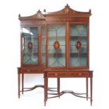 A pair of reproduction mahogany, satinwood banded and marquetry bookcases on stands,