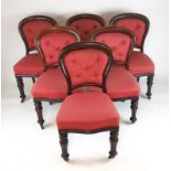 A set of six Victorian mahogany balloon back dining chairs upholstered in a red button back fabric,