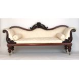 A Victorian mahogany framed settee upholstered in a floral white gold fabric,