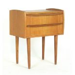 A 1960's oak two-drawer bedside cabinet on circular tapering legs, w.