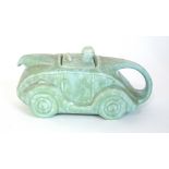 A Sadler teapot modelled as a racing car in mottled green, l.