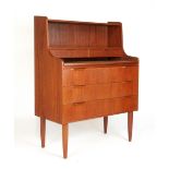 A 1960/70's teak bureau, the two short drawers over a slide and three long drawers on tapering legs,