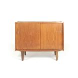 A 1960's teak cabinet with two sliding doors, on tapering feet, in the manner of Poul Hundevad, l.