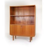 A 1960/70's teak open bookcase, the adjustable shelf over a fall-front enclosing a fitted interior,