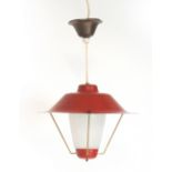 A 1950's red enamelled ceiling light with three brass finished supports and an etched glass shade