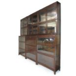 An early 20th century oak Gunn sectional bookcase, comprising of twelve glazed bookcase sections,