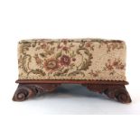 A 19th century mahogany footstool upholstered in a floral fabric on carved feet, h. 18 cm, w.