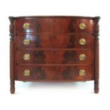 An early 19th century bow front chest of drawers,