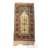 A hand woven Persian prayer rug,