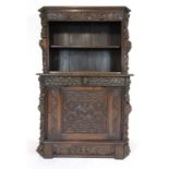 An early 20th century oak bookcase incorporating earlier carvings including caryatid's and lion