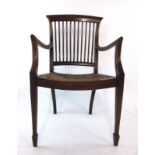 A late 19th century walnut open arm chair,