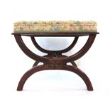 An early 19th century rosewood X-framed stool upholstered in a buttoned floral fabric over a turned