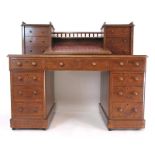 A late 19th century oak twin pedestal desk, the top with two galleried,