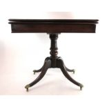 An early 19th century mahogany tea table,