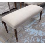 LONG STOOL, upholstered in a natural fabric, on turned reeded supports, 40cm D x 97cm L x 51cm H.
