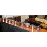 GRADUATED COPPER PANS, a set of five, the largest 20cm diam and another set of four.