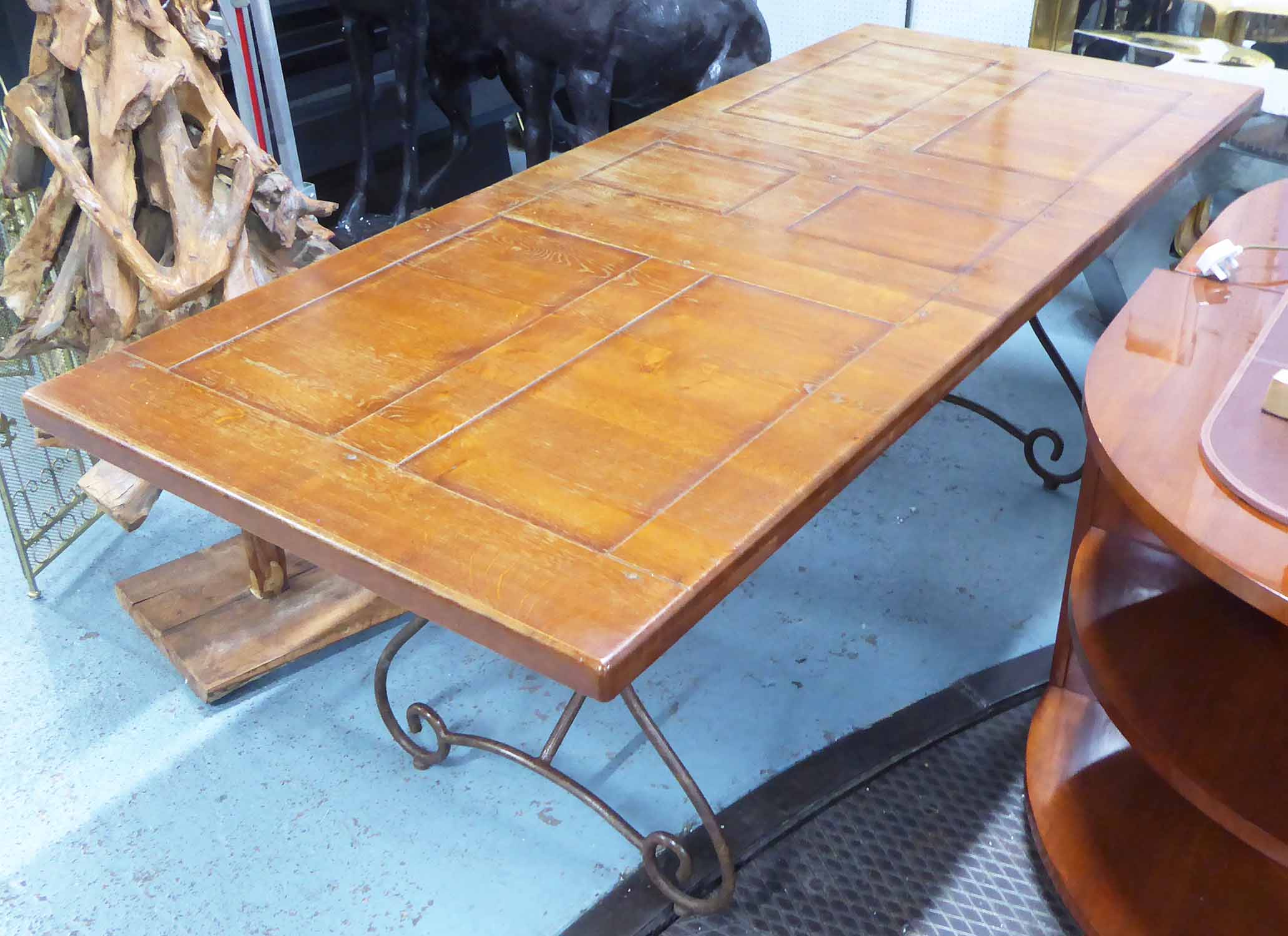 DINING TABLE, Spanish style, the panelled wooden top on scrolled metal legs, 84cm x 78cm H x 201cm.