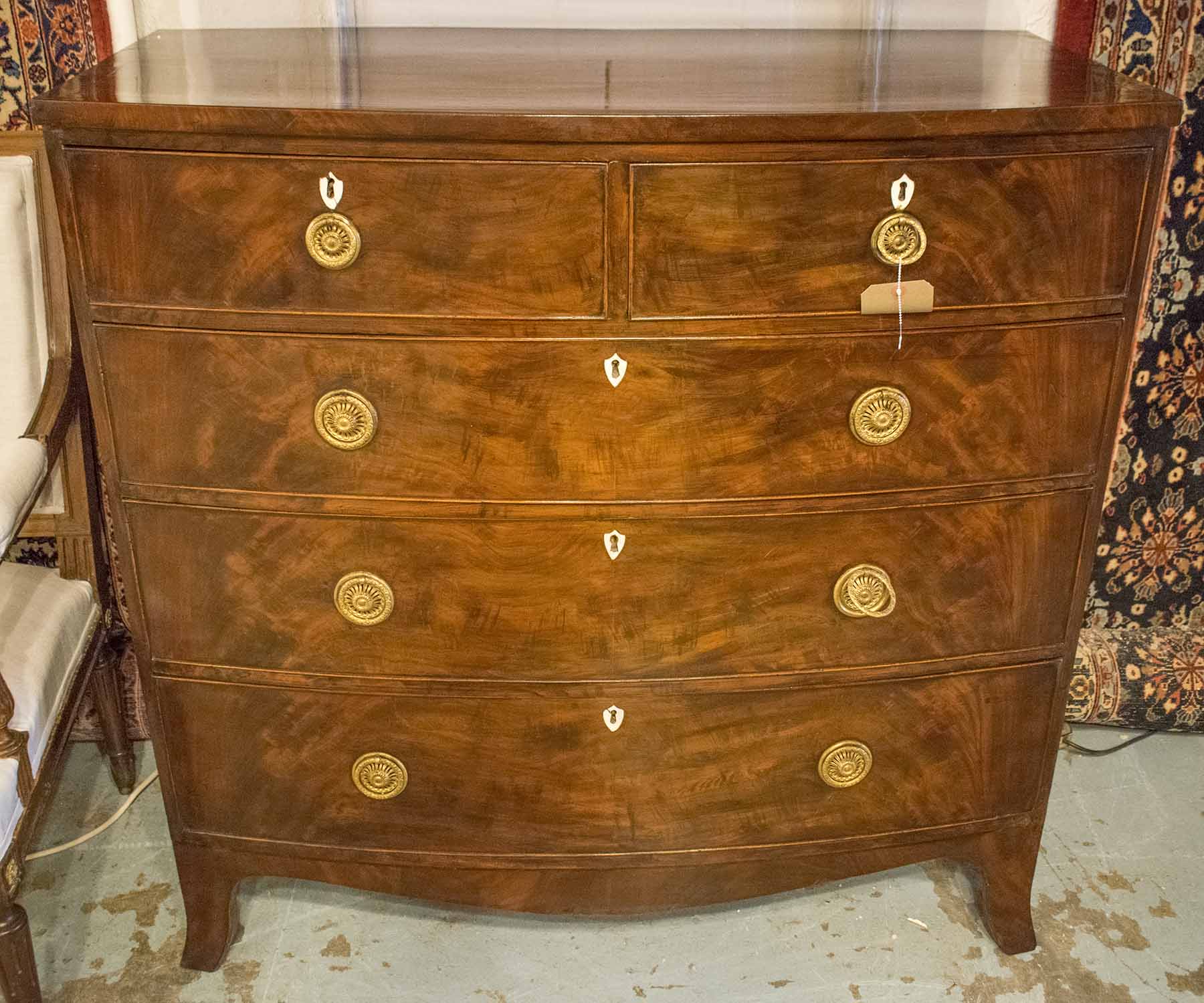 BOWFRONT CHEST, Regency flame mahogany, with two short and three long drawers,