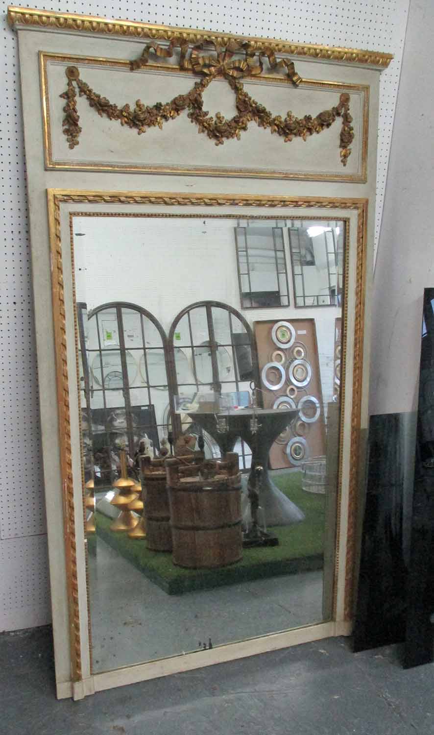 TRUMEAU MIRROR, bevelled plate with gilded swags and frame on a cream ground, 181cm x 104cm.