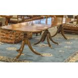 TRIPLE PILLAR DINING TABLE, Regency and later mahogany, on turned columns and swept supports,
