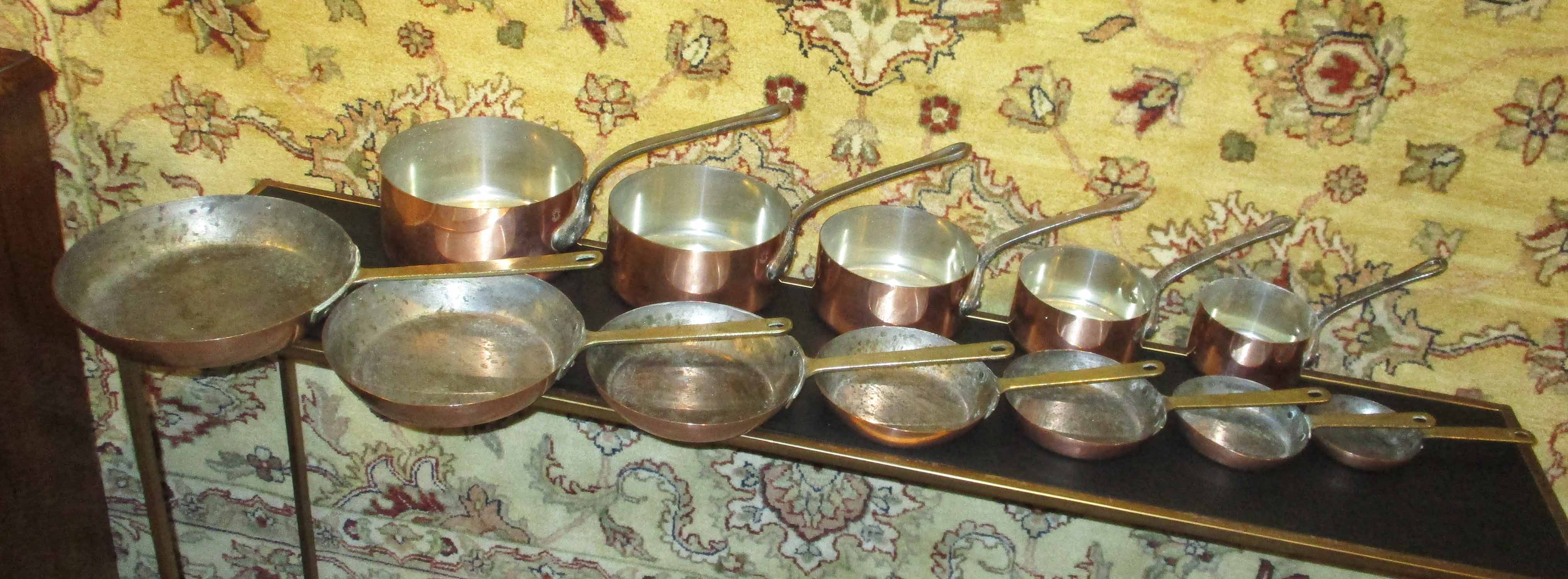 GRADUATED COPPER PANS, a set of five,