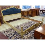 KINGSIZE BED, Italian carved giltwood and polychrome with a buttoned upholstered headboard,