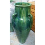 PERSIAN WINE VESSELS, a pair, in green glaze, 92cm H.