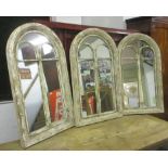WALL MIRRORS, a set of three, distressed wooden framed, each with an arched top, 55cm W x 94cm H.