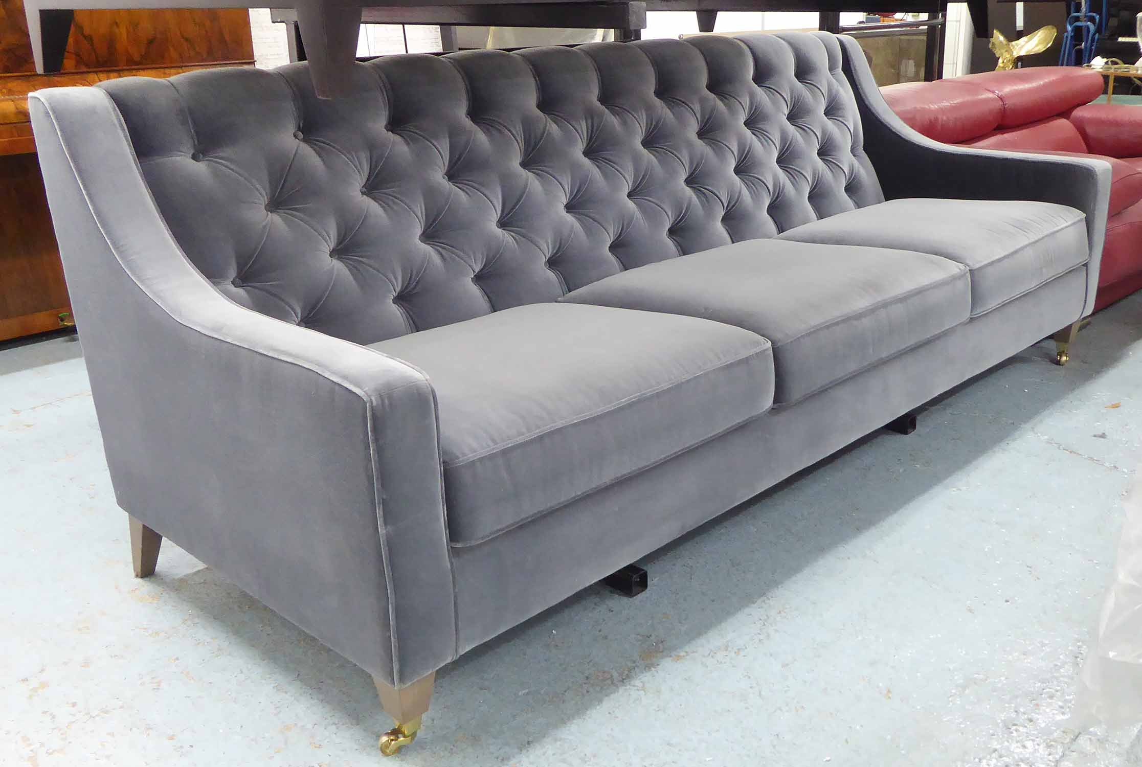 SOFA, three seater, in grey button back velvet, on square castor support, 240cm L.