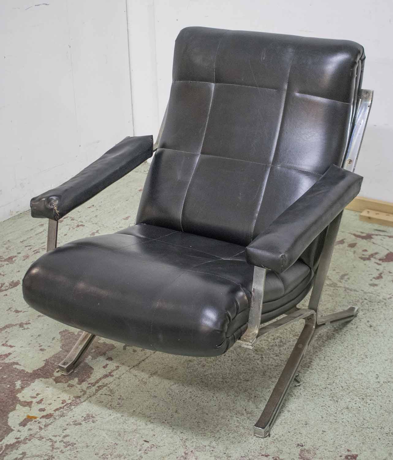 ARMCHAIR, mid 20th century, in black leatherette on steel supports, 74cm W.
