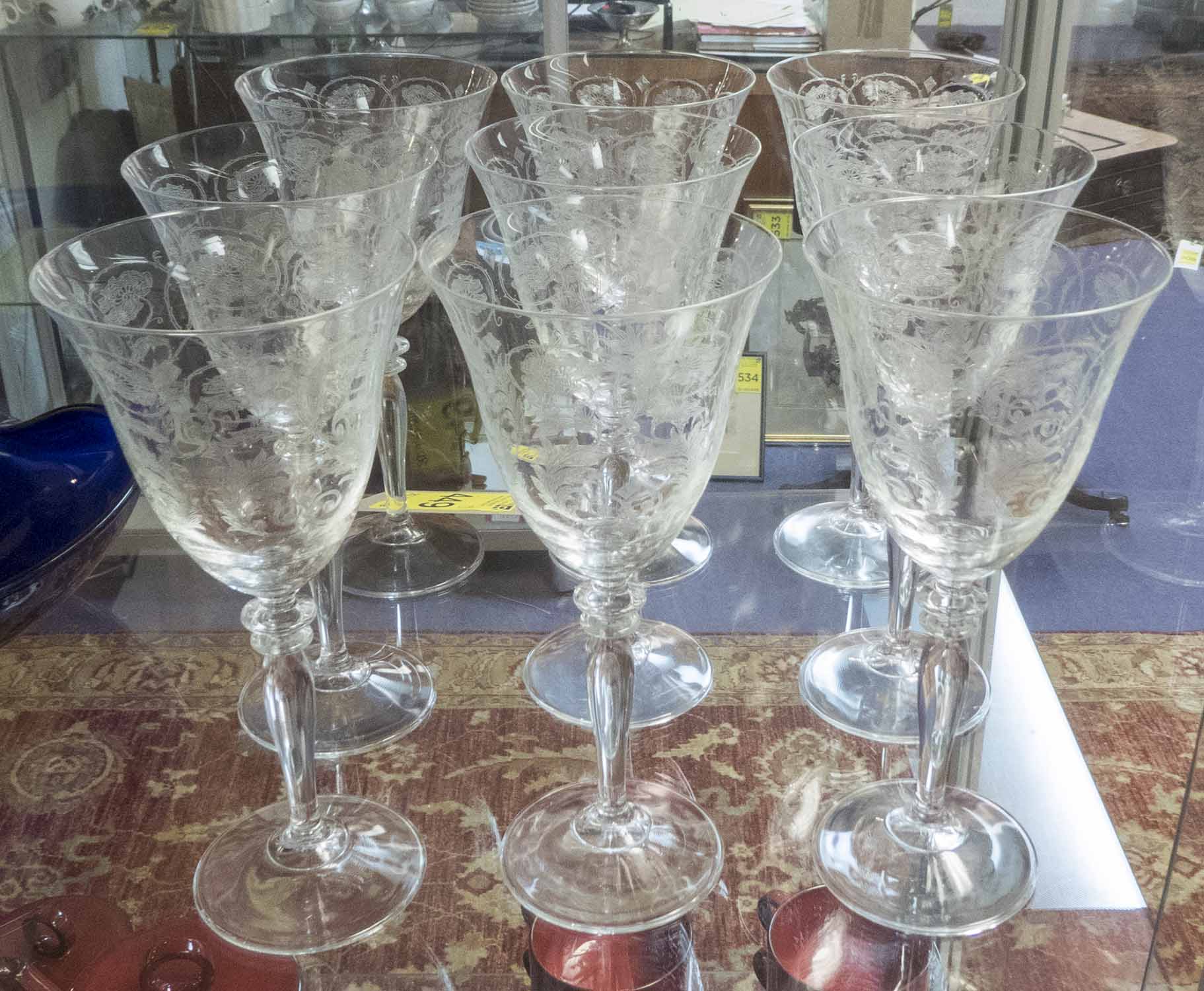 SWEDISH WINE GLASSES, a set of nine, the large bowls with entwined foliate decoration, each 22.