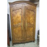 ARMOIRE, early 19th century French cherrywood, with a carved arched pediment,