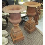 FLUTED URNS ON PEDESTALS, a pair, in rustic cast iron finish, 101cm H.