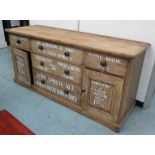 SIDEBOARD, Victorian pine, with drawers and cupboard doors later decorated with shop signage,
