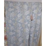 CURTAINS, a pair, in a woven blue fabric, lined, with rings to top,