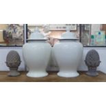 BALUSTER VASES, a pair, lidded, white glaze, each 66cm H, and a pair of pineapple finials, 33cm H.