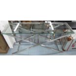 ANDREW MARTIN STYLE CONSOLE TABLE, glass top on an X framed polished metal base,