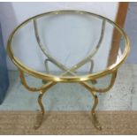 SIDE TABLE, a circular glass top on a polished brass base, 66cm W x 63cm H.