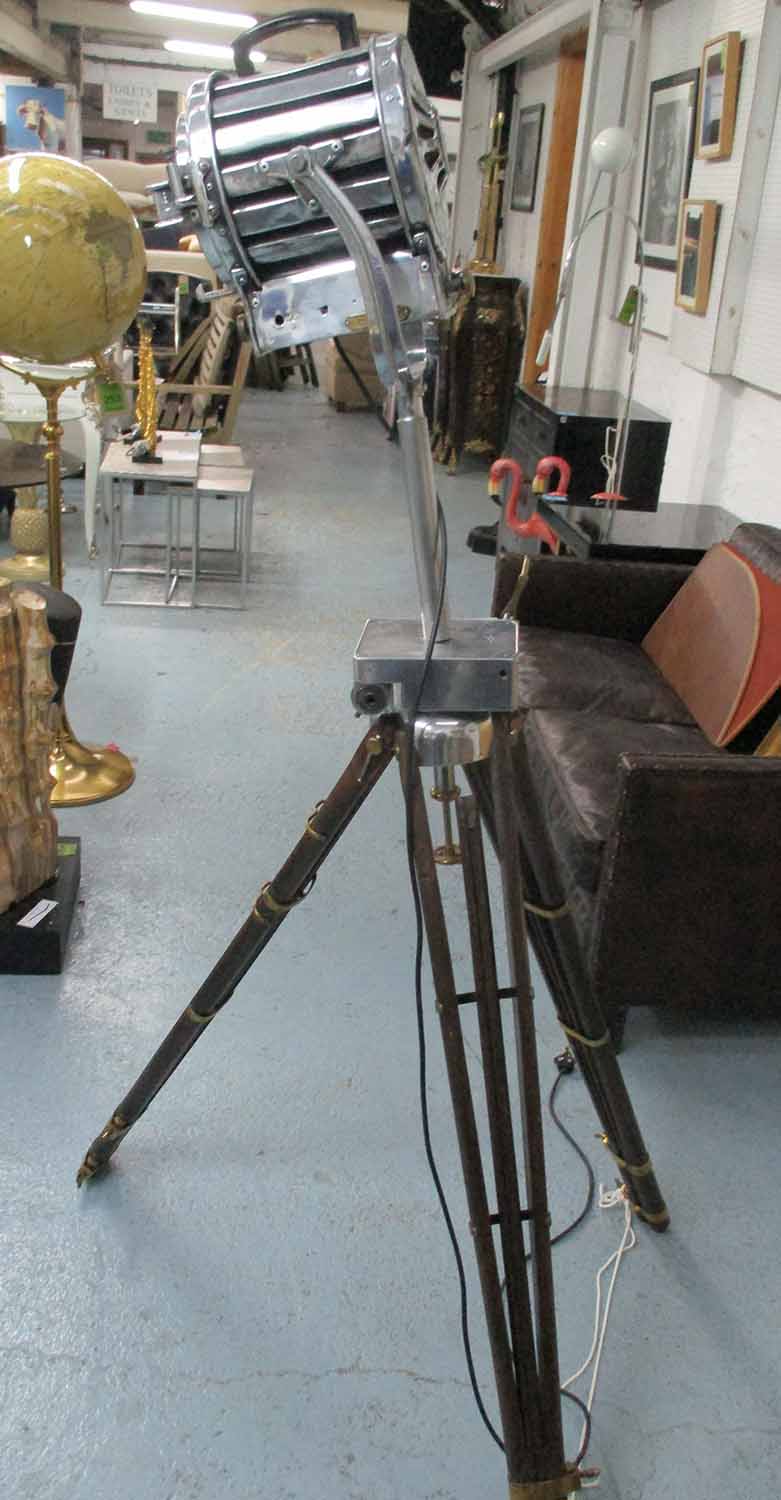 EARLY 20TH CENTURY SPOTLIGHT, French, in chromed metal with extending wooden tripod supports,