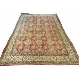 FINE PERSIAN KASHAN CARPET, all over palmette and scrolling vine design with a turquoise border,