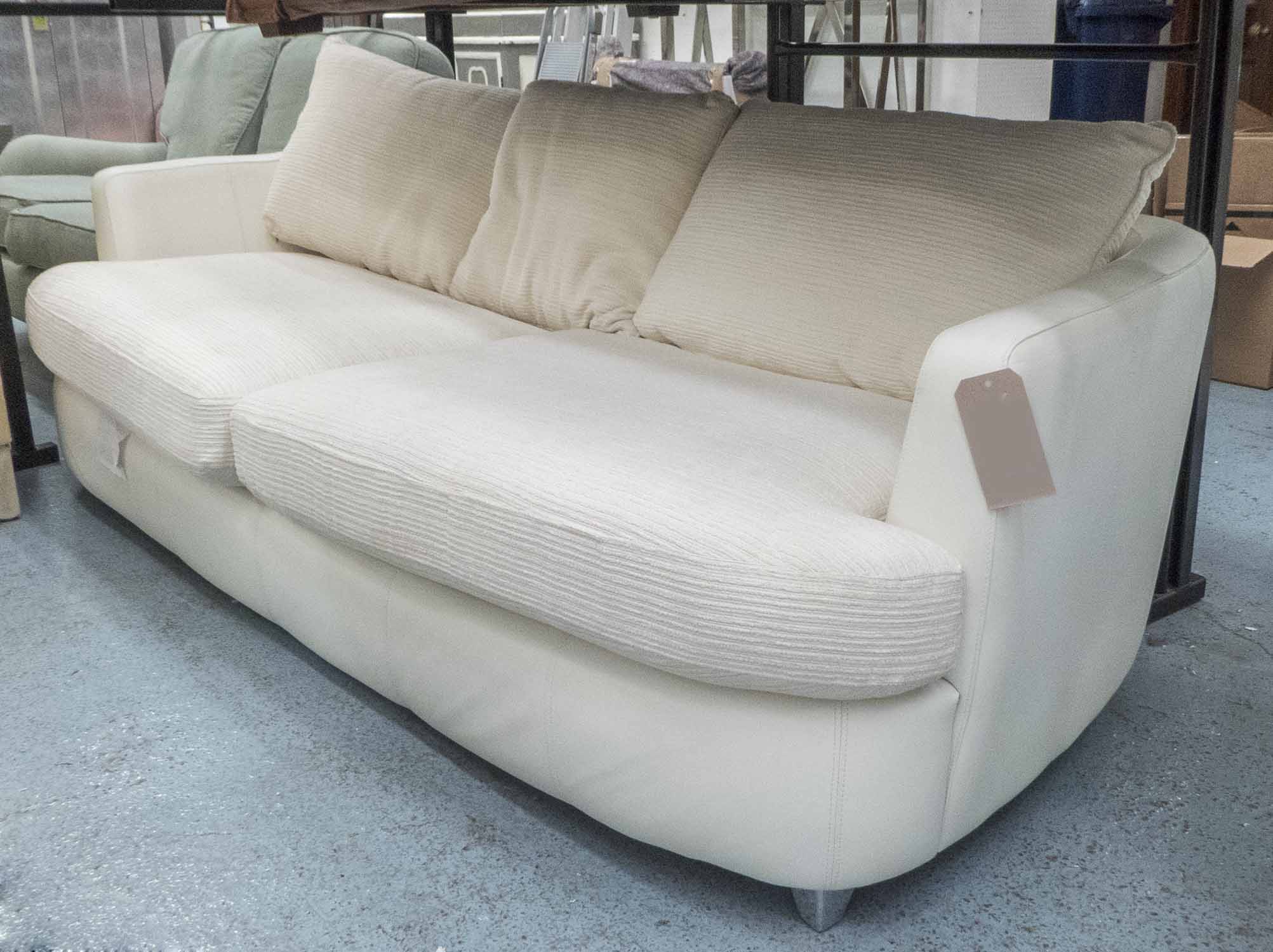 SOFA, large two seater, in cream leather and cream fabric on metal supports, 231 cm long.