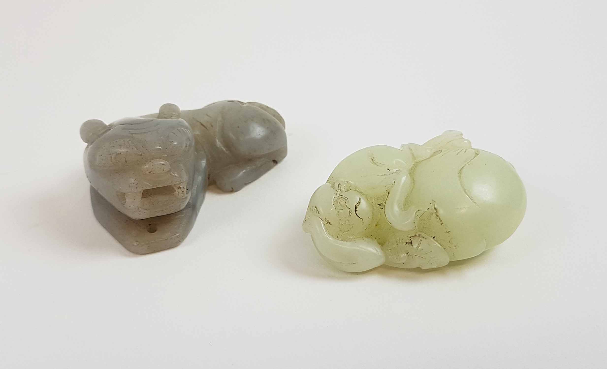 A CHINESE DALE CELADON COLOURED JADE MONKEY AND GOURD and a greyish coloured Jade recumbant lion,