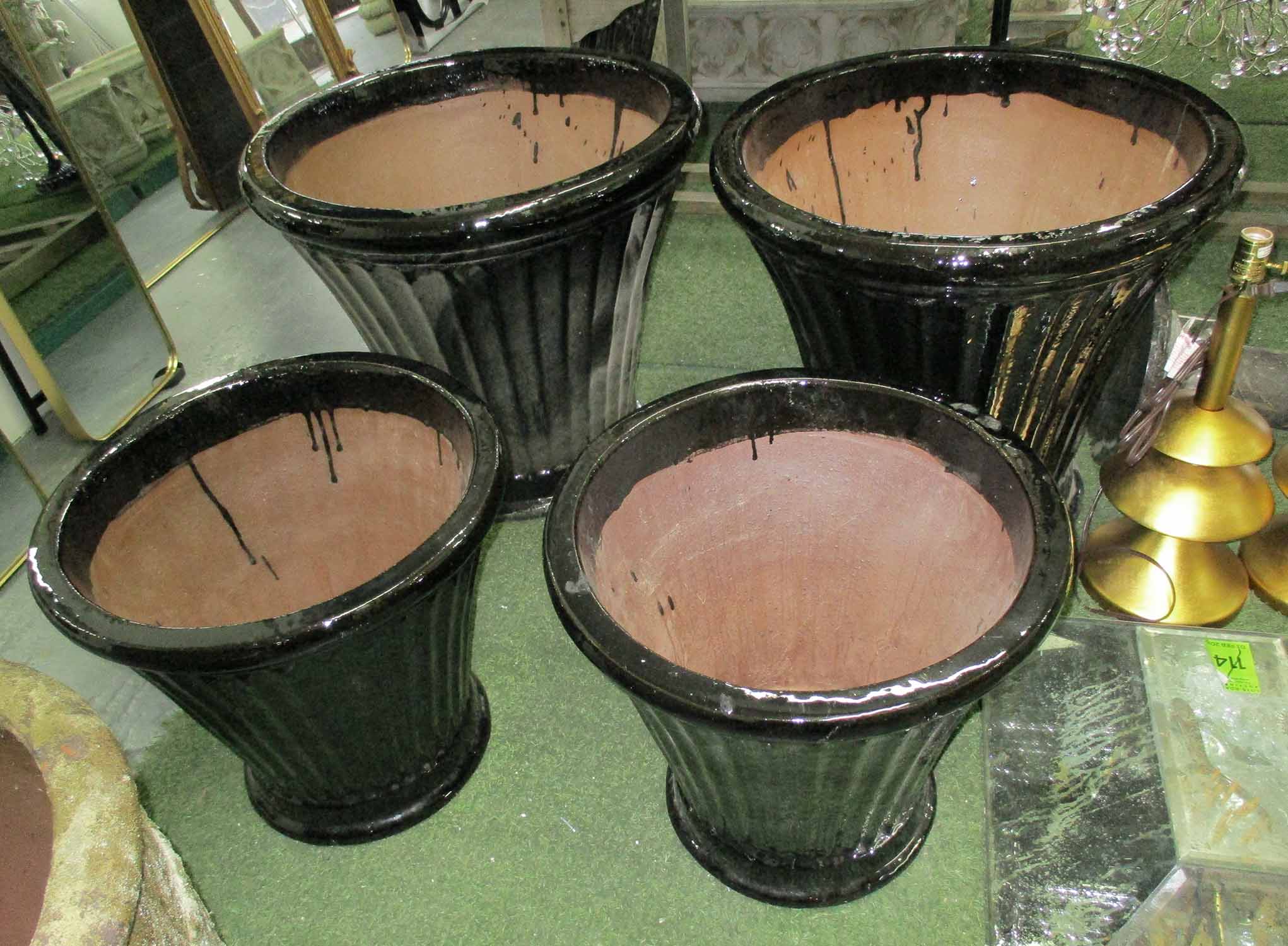 PLANTERS, two pairs, glazed fluted in black, large 57cm H, small 46cm H.