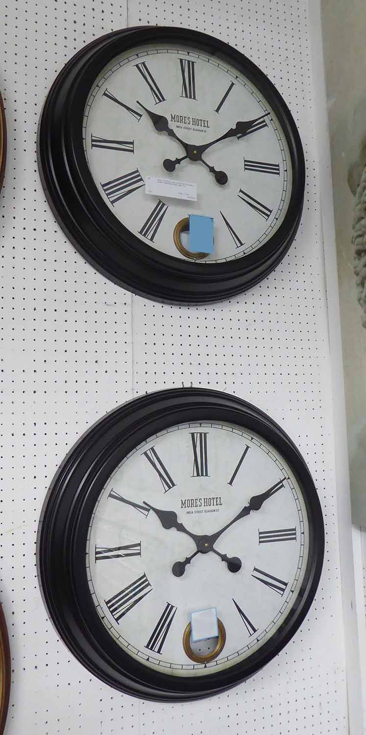 WALL CLOCKS, a pair, with Roman numerals in a black metal frame, 58cm diam. - Image 2 of 2