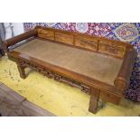 BENCH, Chinese elm with rattan seat and rolling bolster arms above two short drawers,