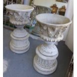 URNS, a pair, reconstituted stone with floral swag design, 91cm H.