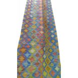 FINE ANATOLIAN KILIM RUNNER, in a fusion of contemporary colours, 297cm x 77cm.